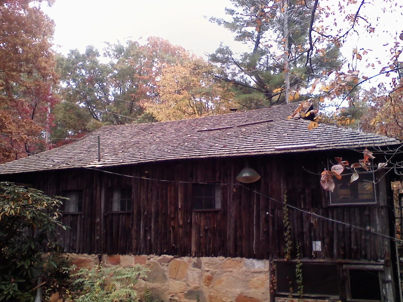 Weathered wood shake roof on a rustic board sided cabin in Toquerville