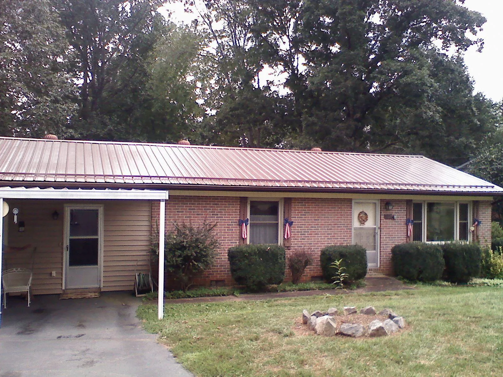 Bronze metal roof and carport on a brick ranch home — Roof Repair work by our crew in Toquerville