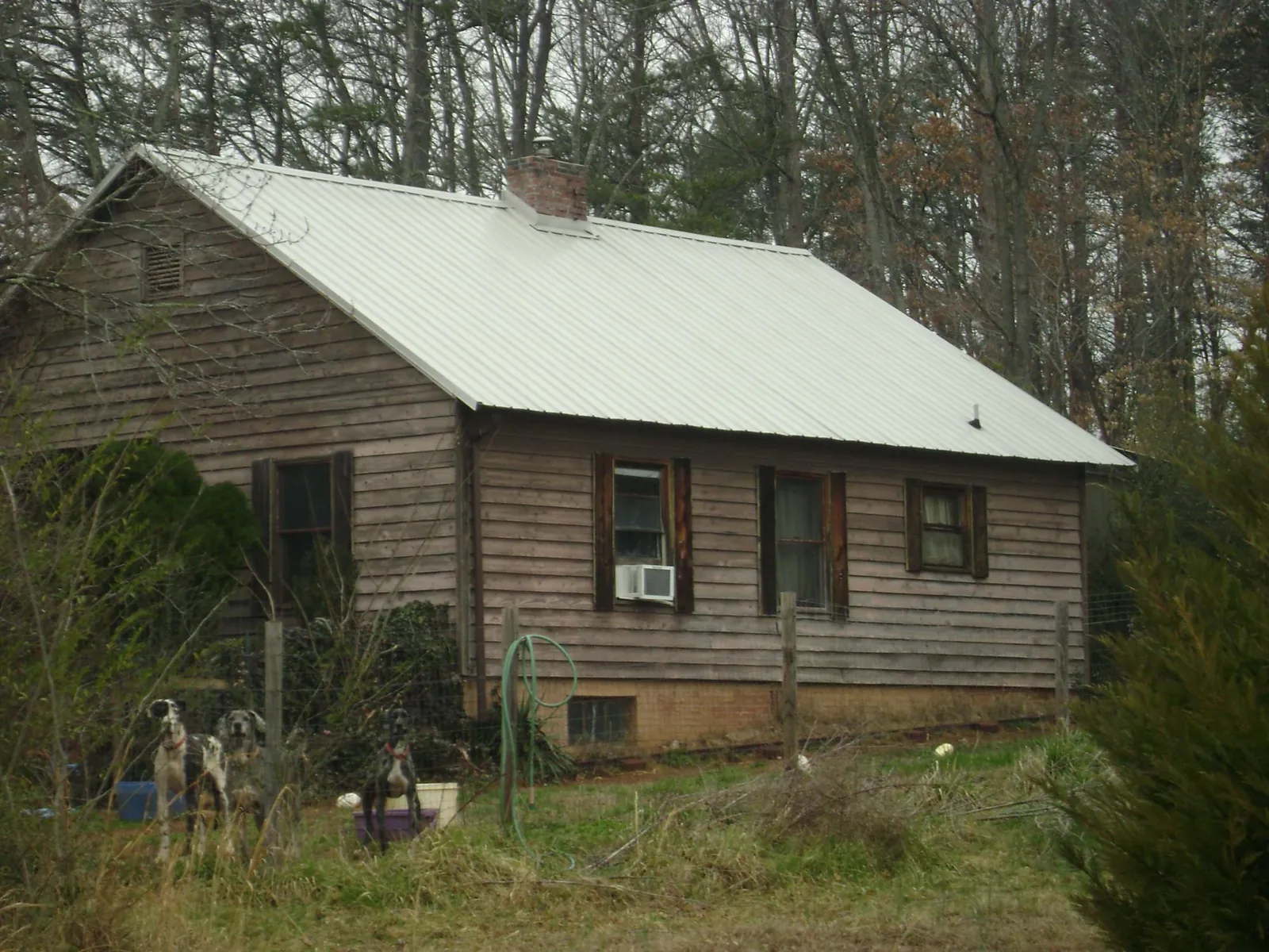 White metal roof on an old wood sided farmhouse, from a Metal Roof Installation job in Toquerville